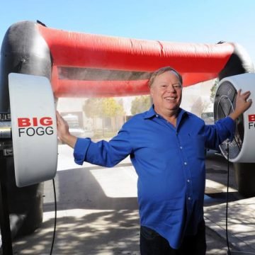 BigFogg CEO Christopher Miehl stands in front of high-pressure misting fans used by many NFL teams. Behind him is another popular product , an inflatable mister at his Temecula office Monday.